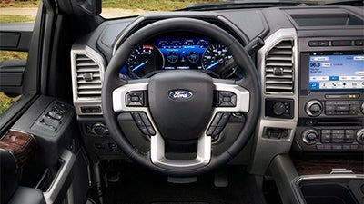 Steering wheel and driver instrumentation inside the truck.