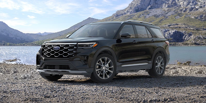 Black Ford Explorer SUV parked in a mountain setting.