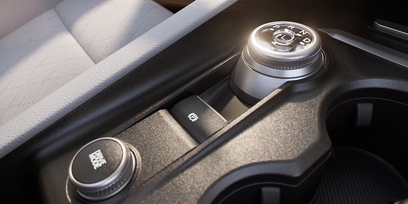 Close-up of the vehicle's rotary gear selector control.