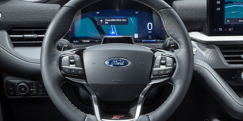 Black perforated leather steering wheel with white stitching 