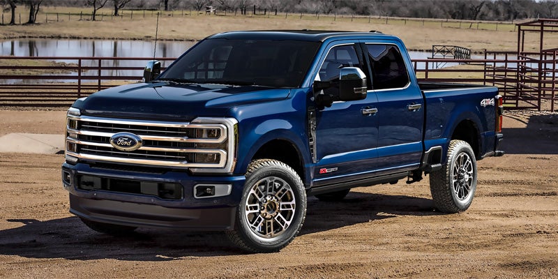 Blue Ford Super Duty truck parked outdoors.