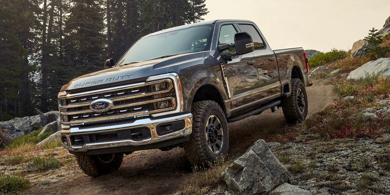 Off-road Ford Super Duty truck on rocky terrain.