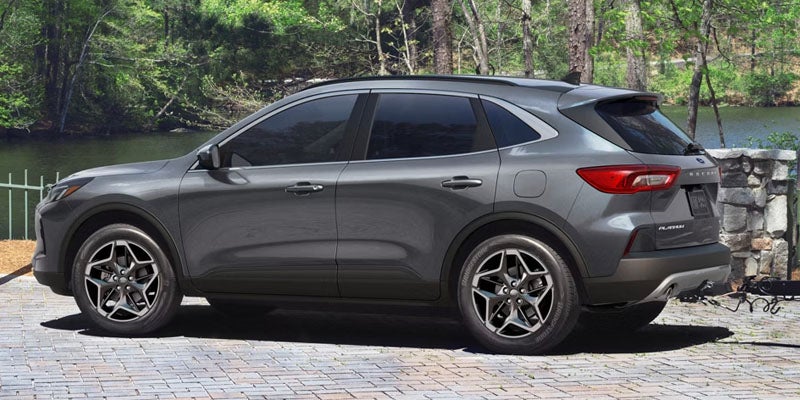 Dark gray Ford Escape SUV parked on a brick-paved surface