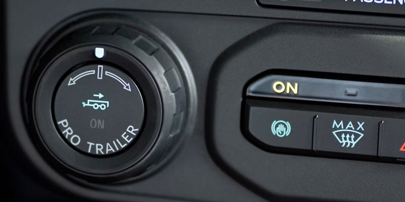 Close-up of a vehicle control button for towing assistance features.