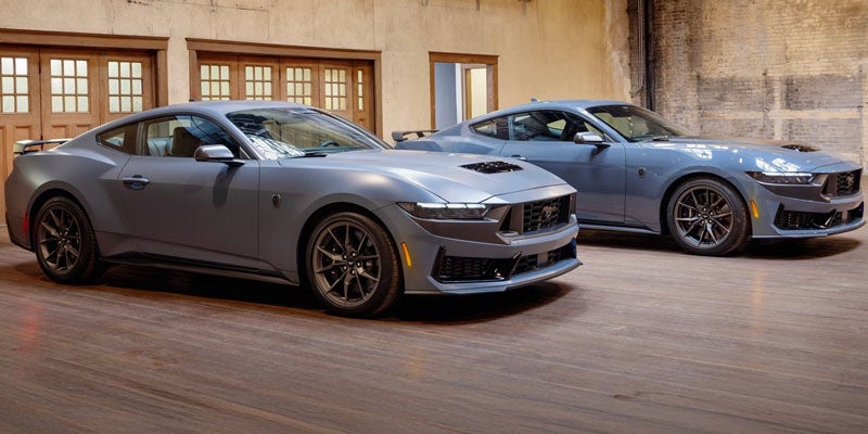 Gray Ford Mustang parked outside a building.
