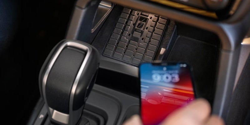 Smartphone placed on the vehicle's wireless charging area.