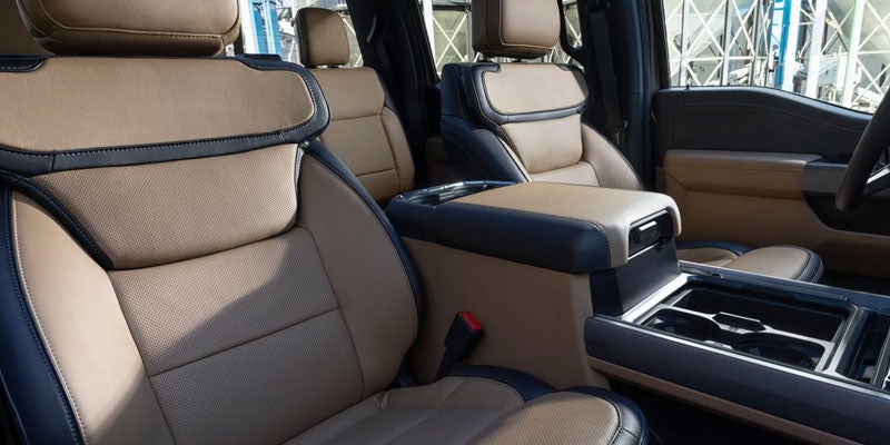 Spacious vehicle interior with premium leather seats and center console.