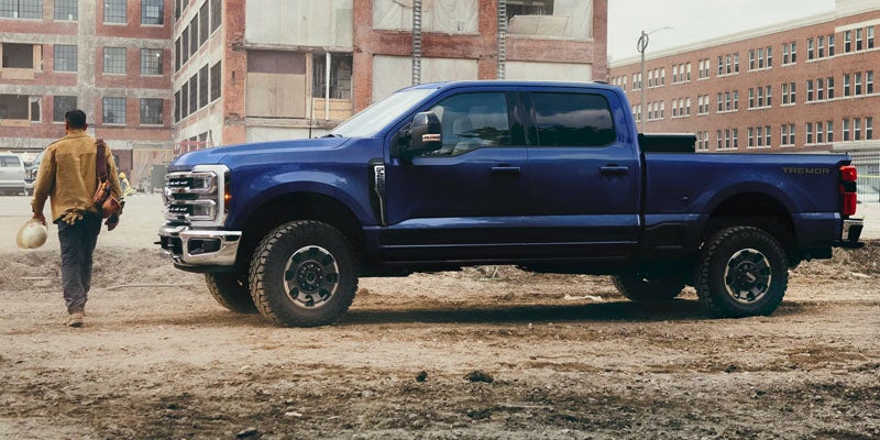 Blue Ford Super Duty truck parked outdoors.