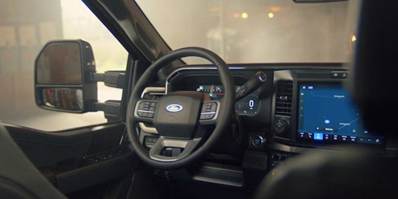 Steering wheel and driver instrumentation inside the truck.